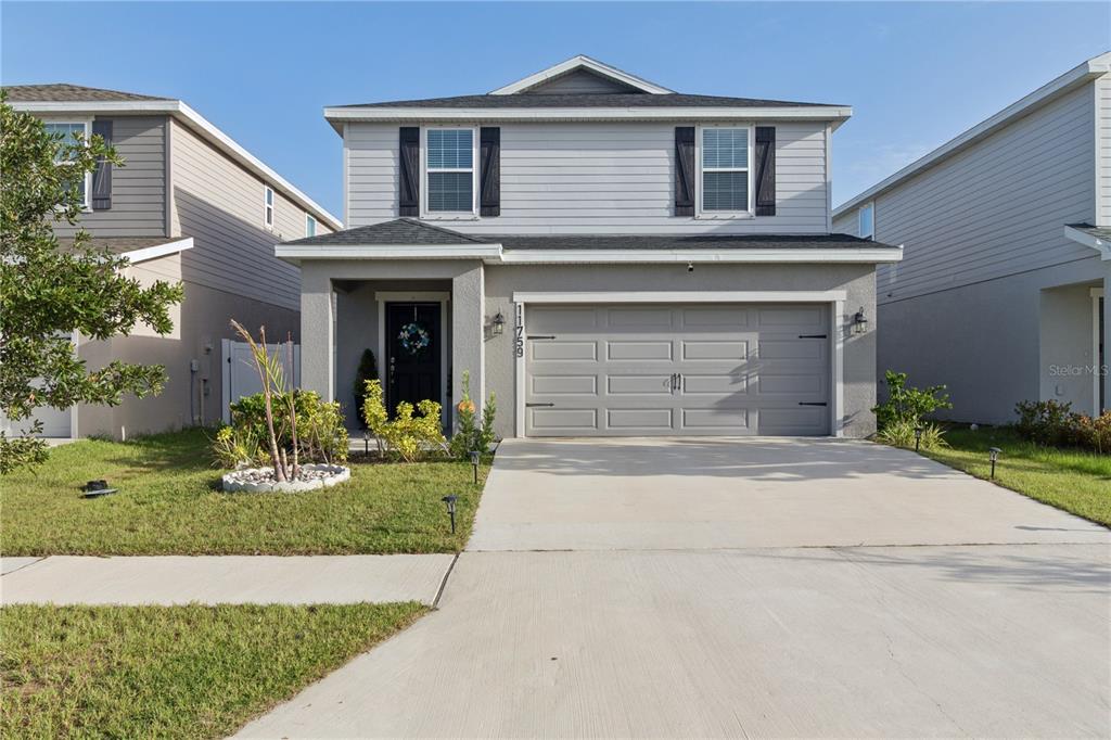 A two-story house with a gray exterior, a two-car garage, and a front lawn — 11759 SABAL SCRUB COURT, RIVERVIEW, FL