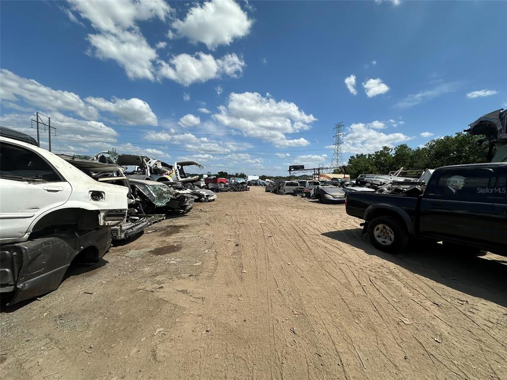 A dirt lot filled with salvaged vehicles under a bright blue sky — 8020 S 78TH STREET, RIVERVIEW, FL