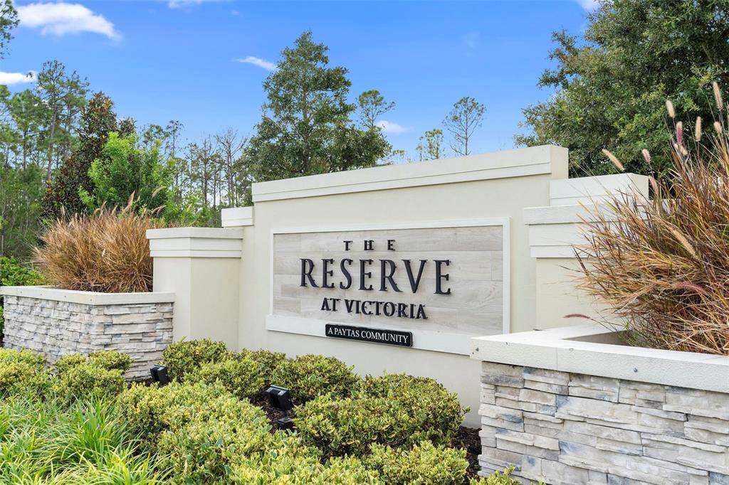 A stone and stucco monument sign marks the entrance to The Reserve at Victoria community — 1548 LAKE RESERVE DRIVE, DELAND, FL