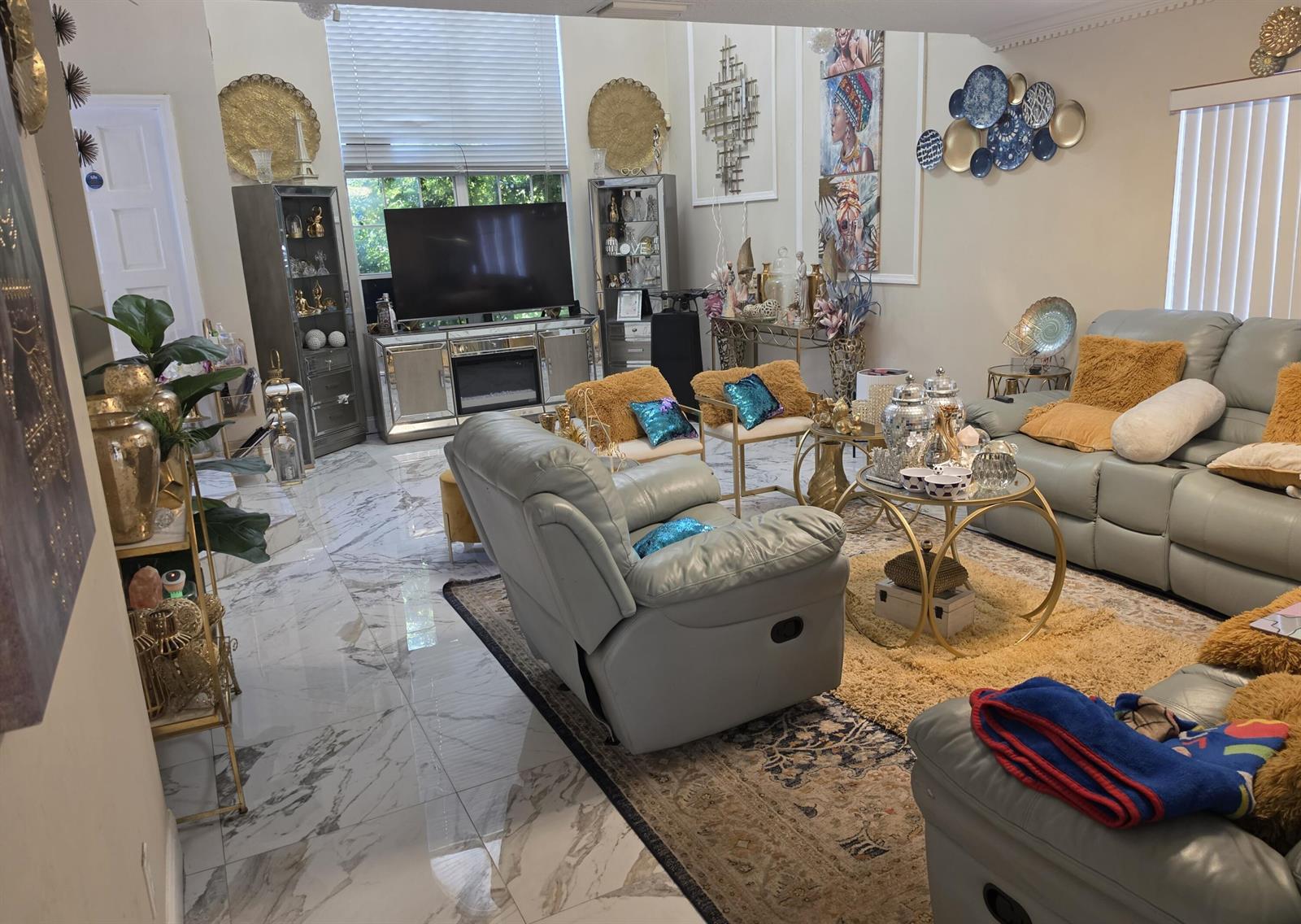A living room features light gray leather furniture, marble flooring, and gold-toned decorative accents — 5351 NW 41st Way, Coconut Creek FL 33073, COCONUT CREEK, FL