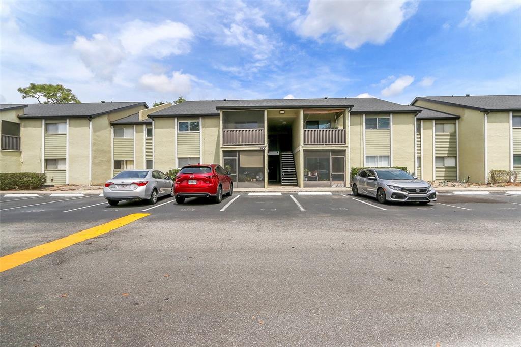 A two-story apartment building exterior with a parking lot in the foreground — 922 LAKE DESTINY ROAD UNIT E, ALTAMONTE SPRINGS, FL