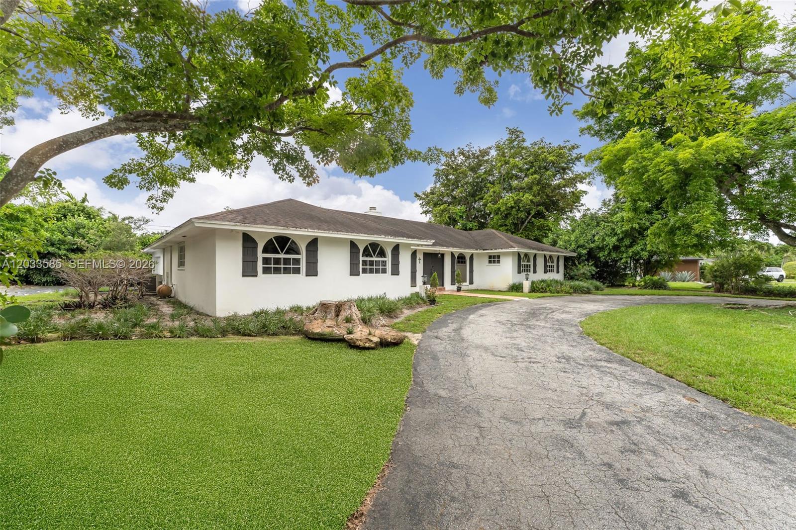 A single-story white house with arched windows and a curved asphalt driveway — 7603 SW 91st Ave, Miami FL 33173, MIAMI, FL