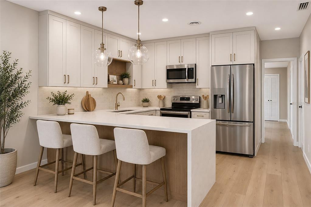 A modern kitchen features white cabinetry, a quartz waterfall island, and stainless steel appliances — 4854 RABAMA PLACE, ORLANDO, FL