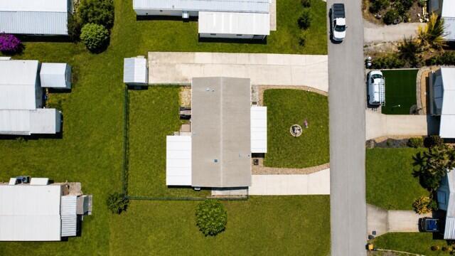 An aerial view shows a mobile home with a driveway, yard, and surrounding properties — 7079 SE Bluebird Circle, Hobe Sound FL 33455, HOBE SOUND, FL