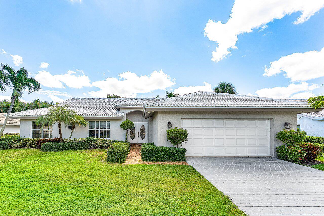 A single-story house with a white tiled roof, gray stucco exterior, and a paved driveway — 4572 White Cedar Lane, Delray Beach FL 33445, DELRAY BEACH, FL