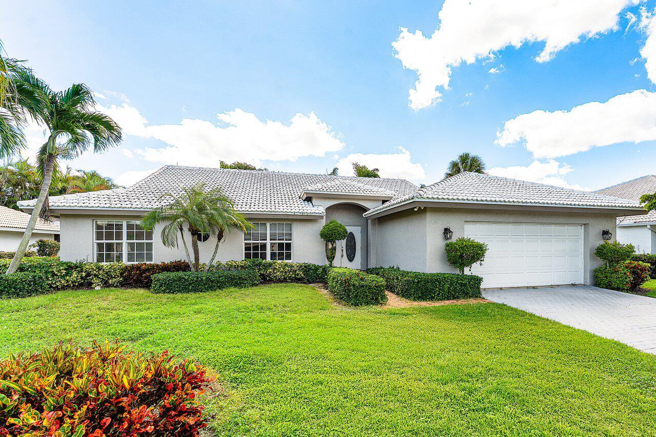 A single-story house with a white tiled roof, light gray exterior, and a two-car garage — 4572 White Cedar Lane, Delray Beach FL 33445, DELRAY BEACH, FL