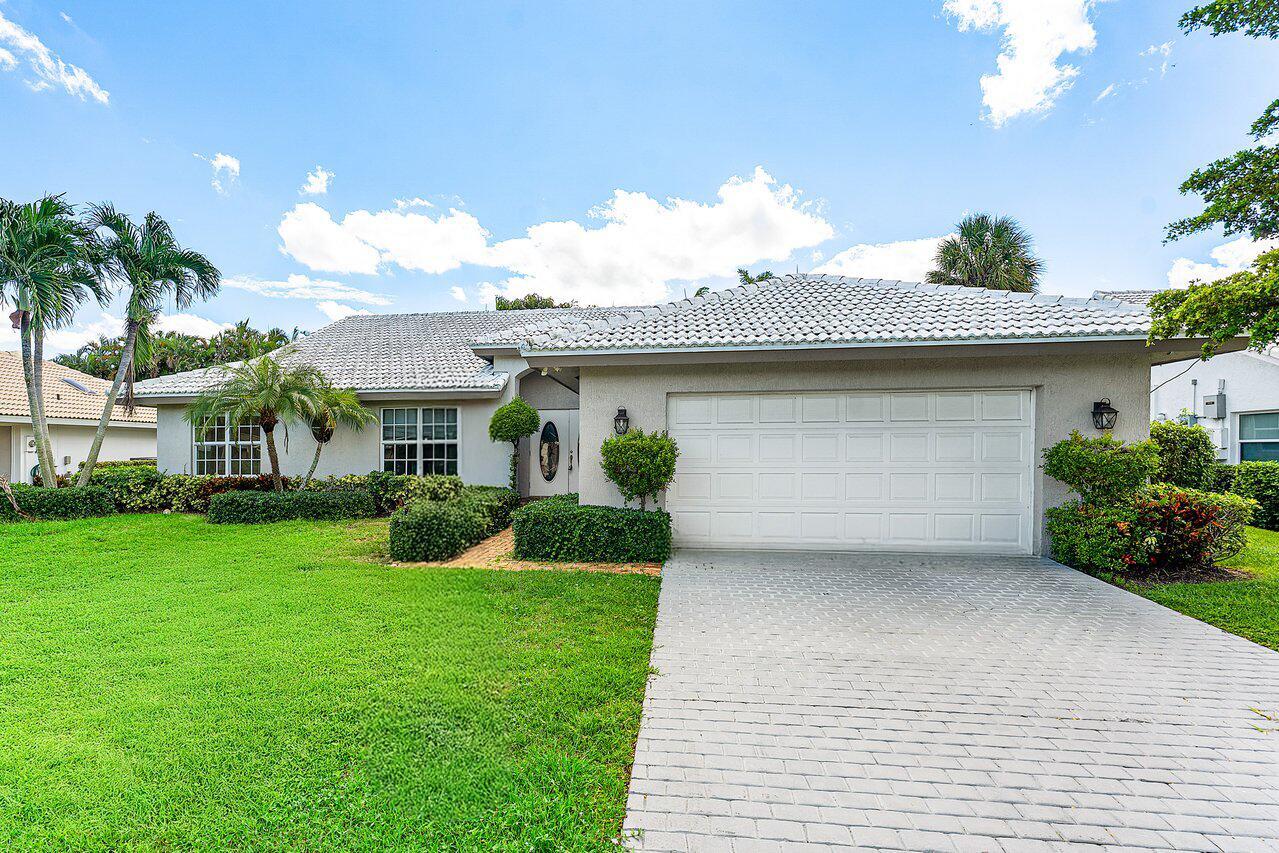 A single-story house with a white tiled roof, a two-car garage, and a paved driveway — 4572 White Cedar Lane, Delray Beach FL 33445, DELRAY BEACH, FL