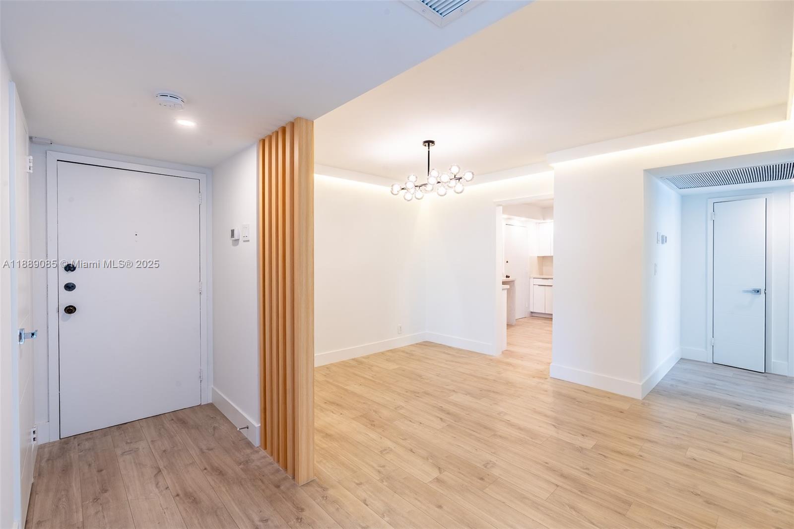 An entryway leads into a bright room with light wood flooring and a wooden slat divider — 2030 S Ocean Dr # 1127, Hallandale Beach FL 33009, HALLANDALE BEACH, FL
