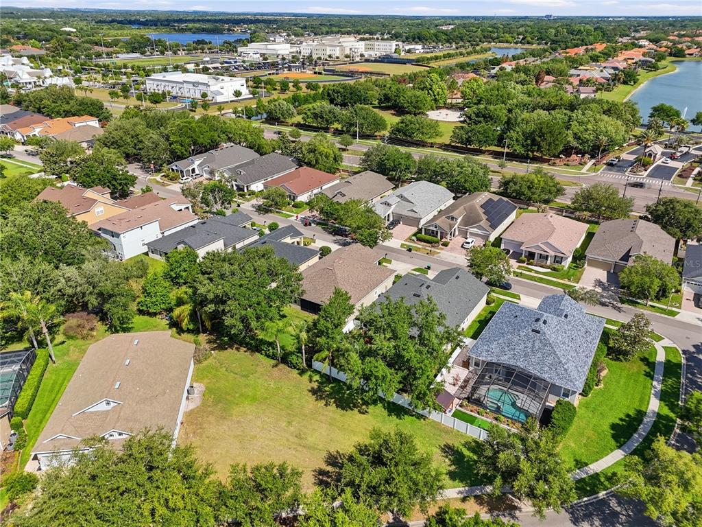 An aerial view of a suburban neighborhood featuring single-family homes, green spaces, and a pool — 13226 ZORI LANE, WINDERMERE, FL