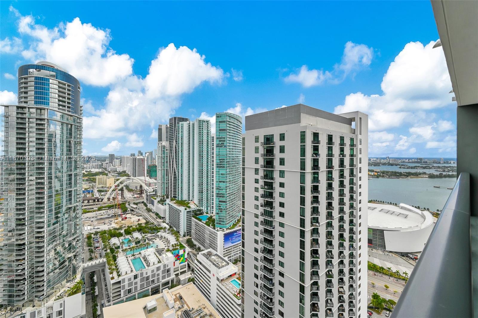 An elevated view of a city skyline featuring multiple high-rise buildings and a waterfront arena — 159 NE 6th St # 3901, Miami FL 33132, MIAMI, FL