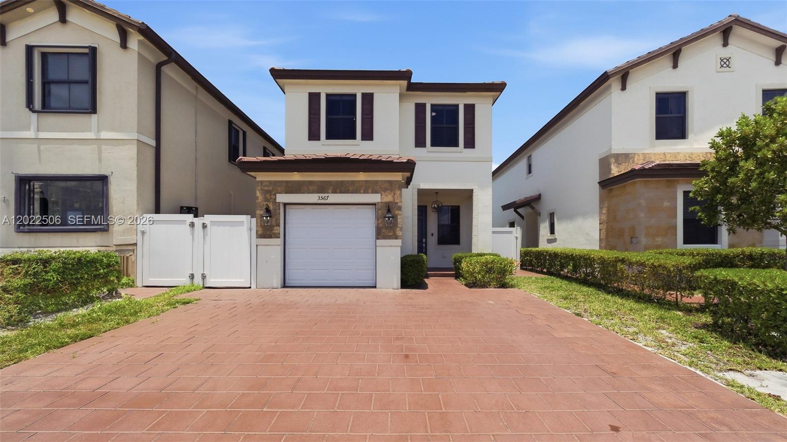 A two-story house features a single-car garage, a paved driveway, and a small front yard — 3567 W 110th Ter, Hialeah FL 33018, HIALEAH, FL