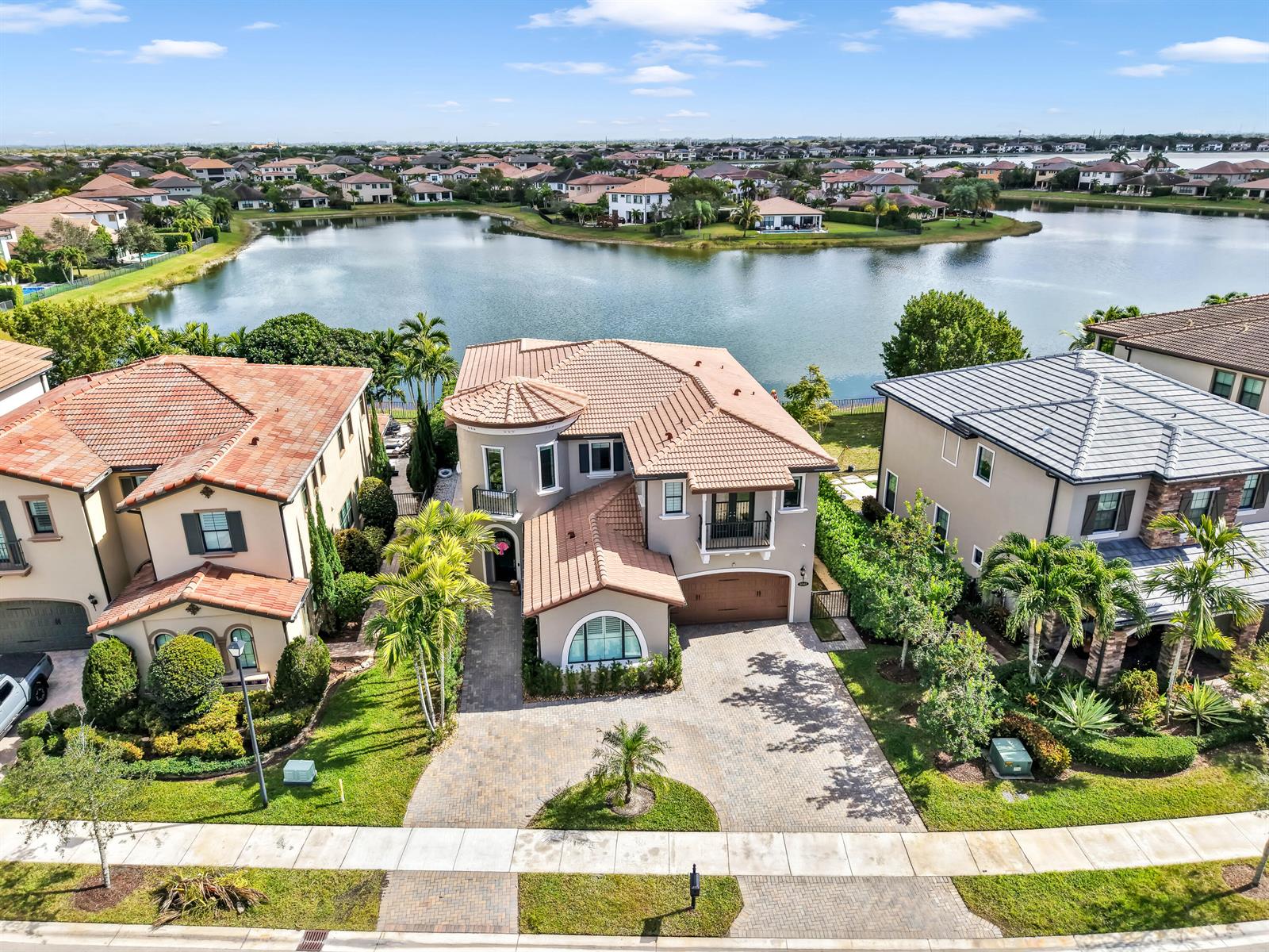 An aerial view shows a two-story house with a tiled roof and a paved driveway — 9040 W Watercrest Cir Circle W, Parkland FL 33076, PARKLAND, FL