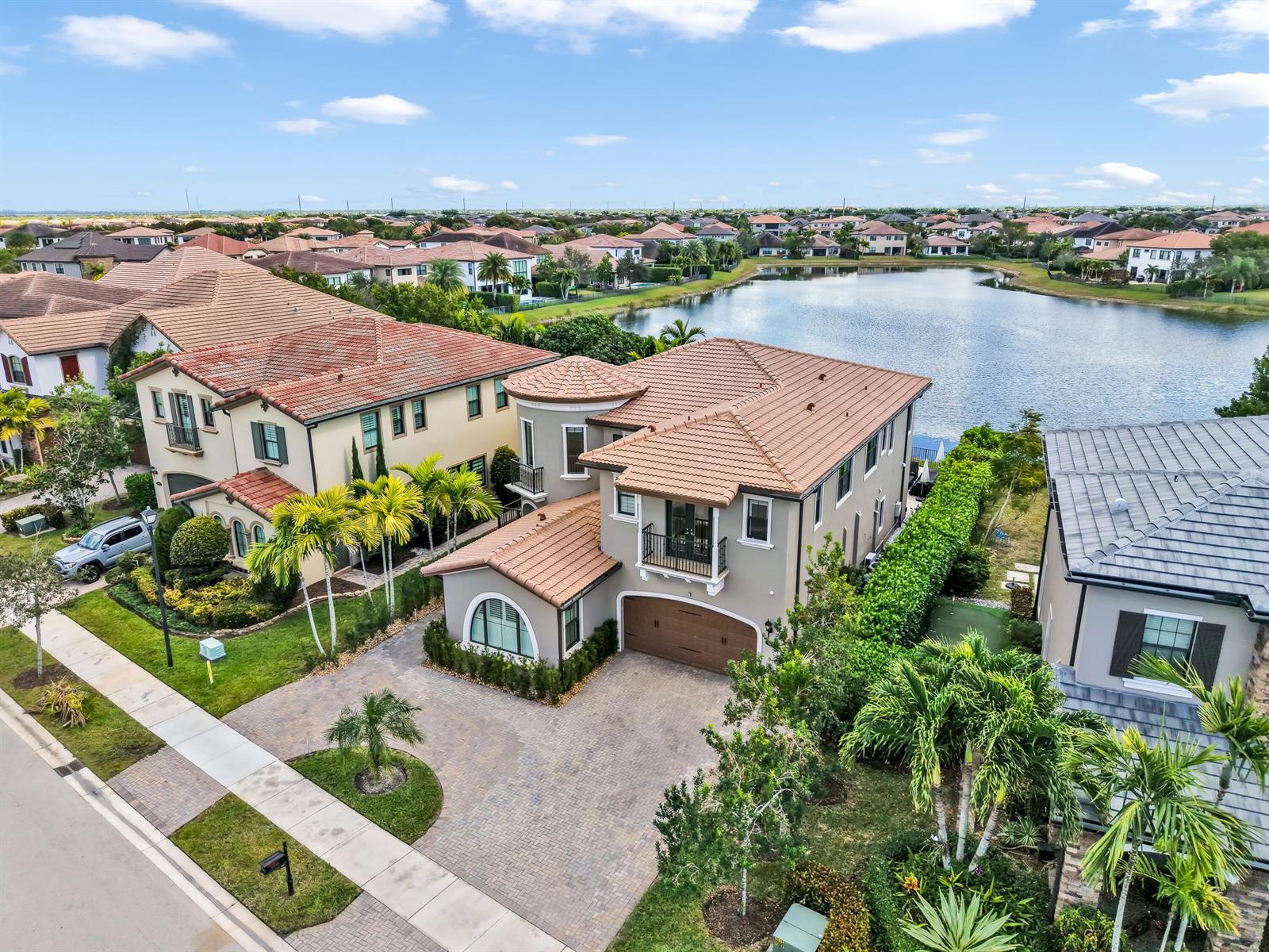 An aerial view shows a two-story suburban house with a tiled roof and paved driveway — 9040 W Watercrest Cir Circle W, Parkland FL 33076, PARKLAND, FL