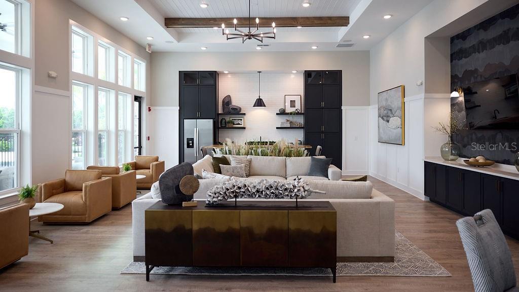 A modern living room features a large sectional sofa, dark cabinetry, and high ceilings — 9500 GRANDTREE AVENUE UNIT A1, VENICE, FL