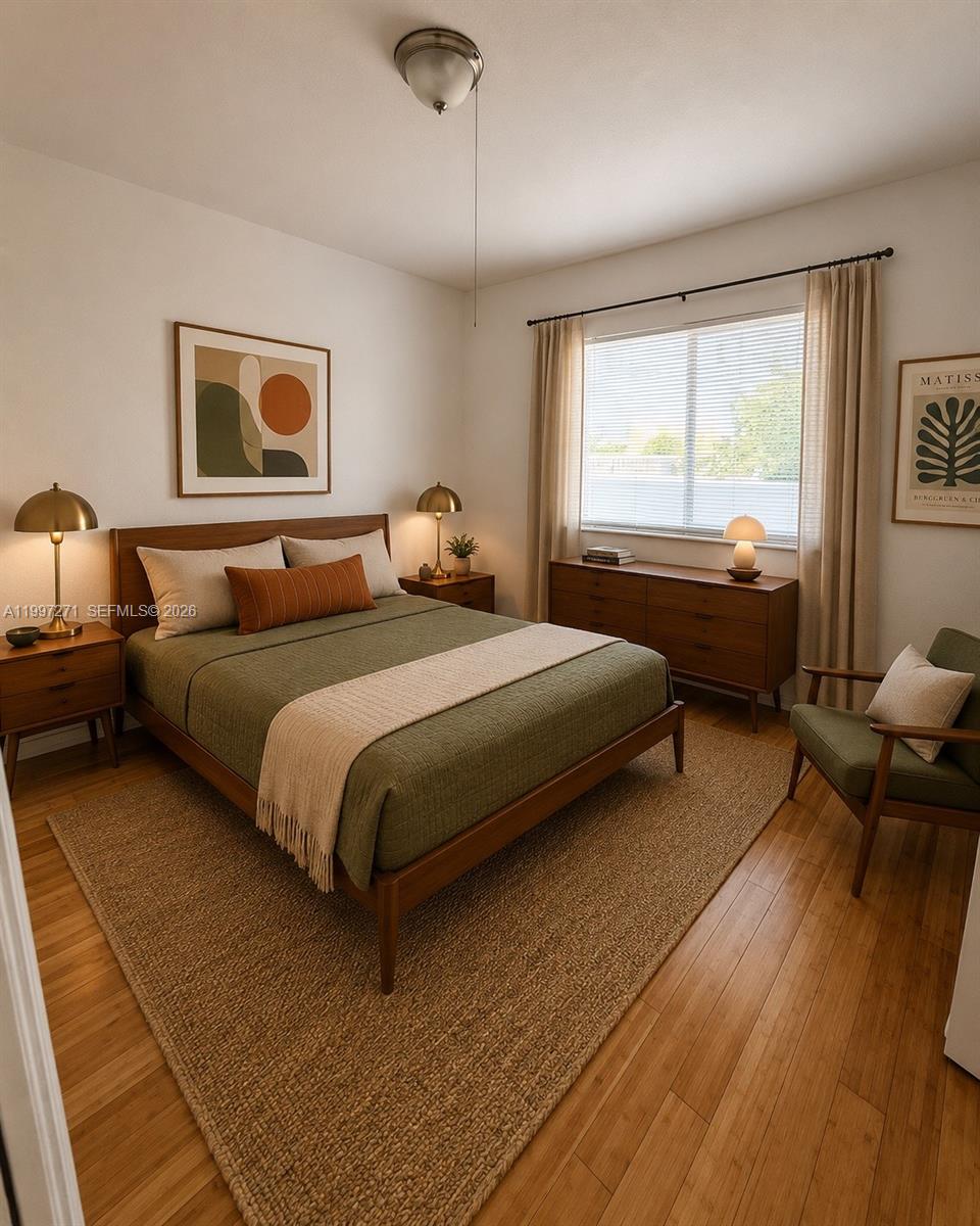 A mid-century modern bedroom features a green bed, wood furniture, and a woven area rug — 36 NW 6th Ave # 504, Miami FL 33128, MIAMI, FL