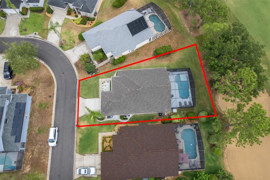 An aerial view shows a house with a pool enclosure and a red property boundary — 1430 PARK PLACE, HAINES CITY, FL