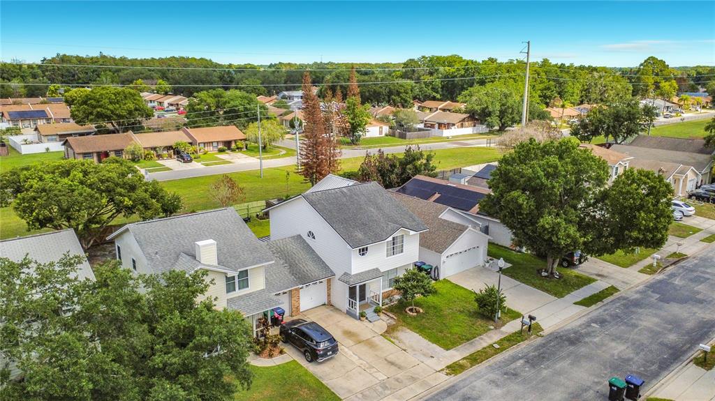 An aerial view shows two adjacent two-story suburban houses with driveways and surrounding trees — 7987 SAGEBRUSH PLACE, ORLANDO, FL