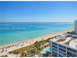 An aerial view of a beach, ocean, and a multi-story building with a pool — 6801 Collins Ave, Miami Beach FL 33141, MIAMI BEACH, FL