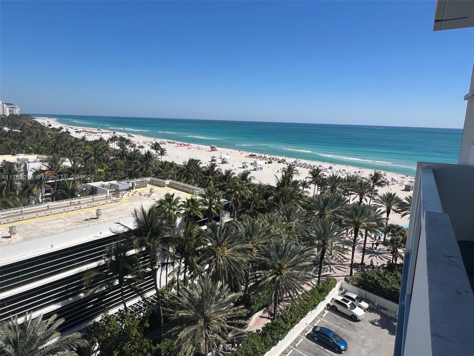 An elevated view shows a beach with palm trees, a parking lot, and the ocean — 100 Lincoln Rd # 945, Miami Beach FL 33139, MIAMI BEACH, FL