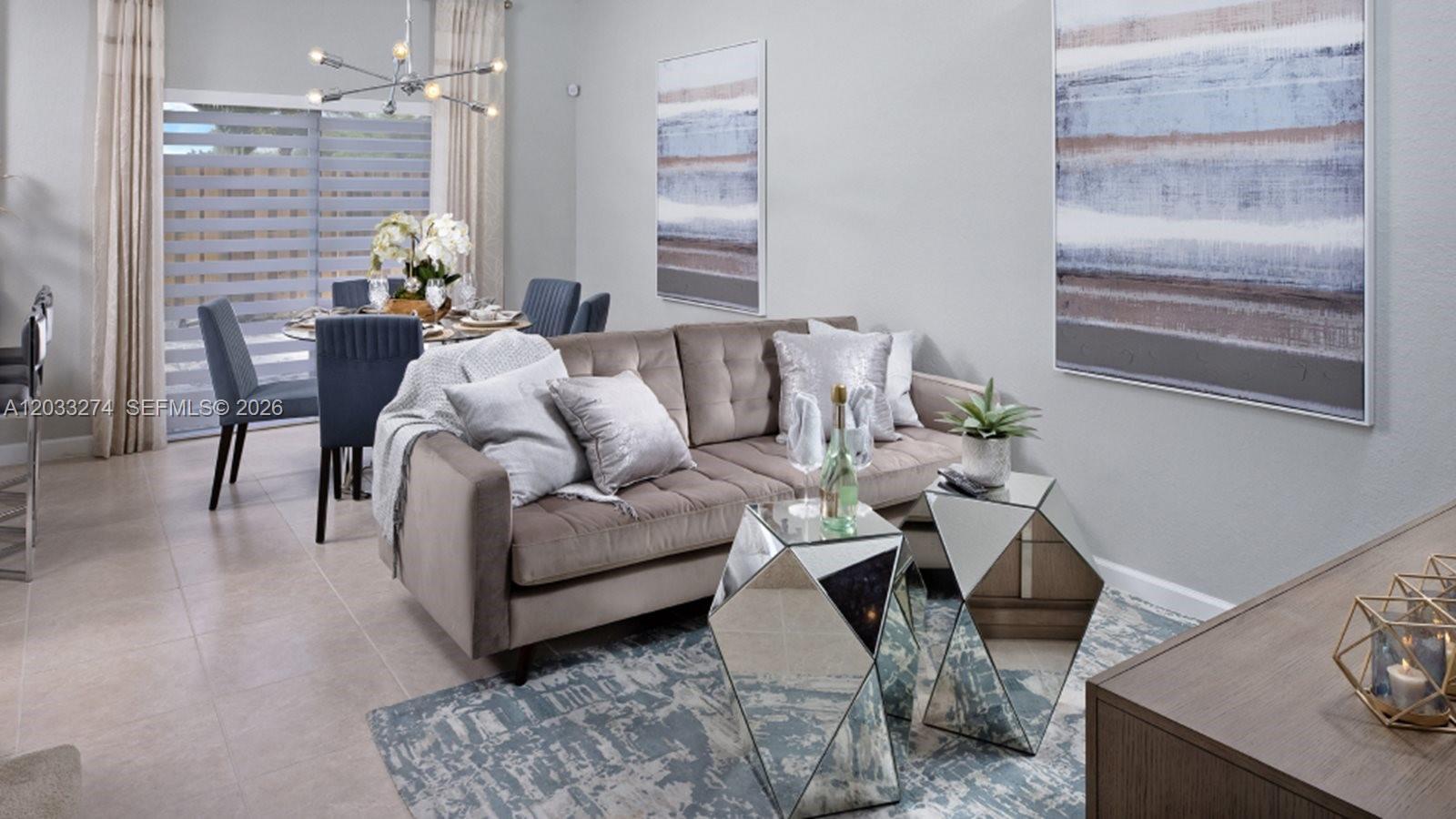 A living room features a velvet sofa, mirrored side tables, and a blue area rug — 2591 SE 26 CT, Homestead FL 33035, HOMESTEAD, FL