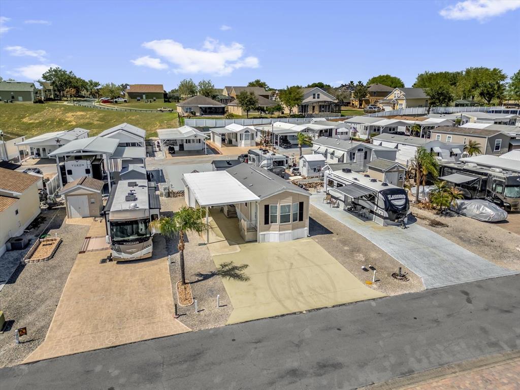 An aerial view shows several manufactured homes and recreational vehicles parked on paved lots — 1039 CENTER CREST BOULEVARD, DAVENPORT, FL