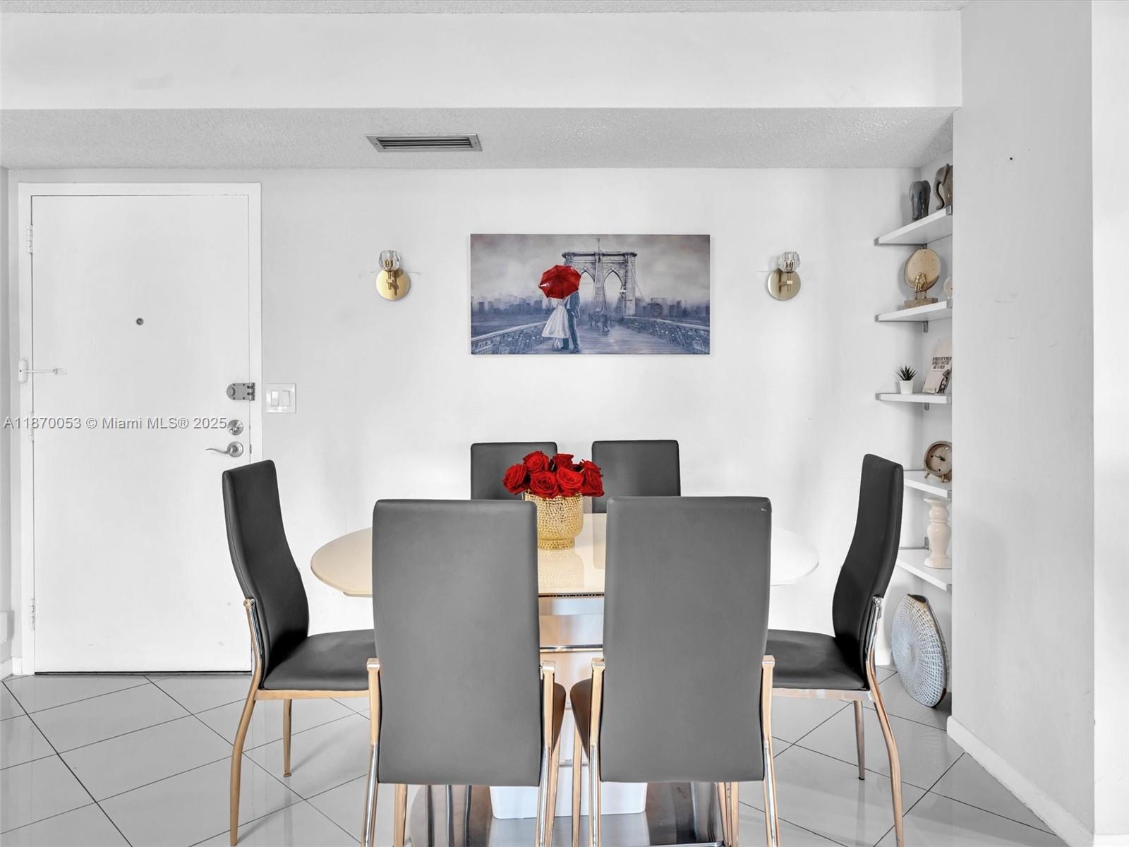 A dining room features a white table, six gray chairs, and wall-mounted art — 1500 S Ocean Dr # 3E, Hollywood FL 33019, HOLLYWOOD, FL