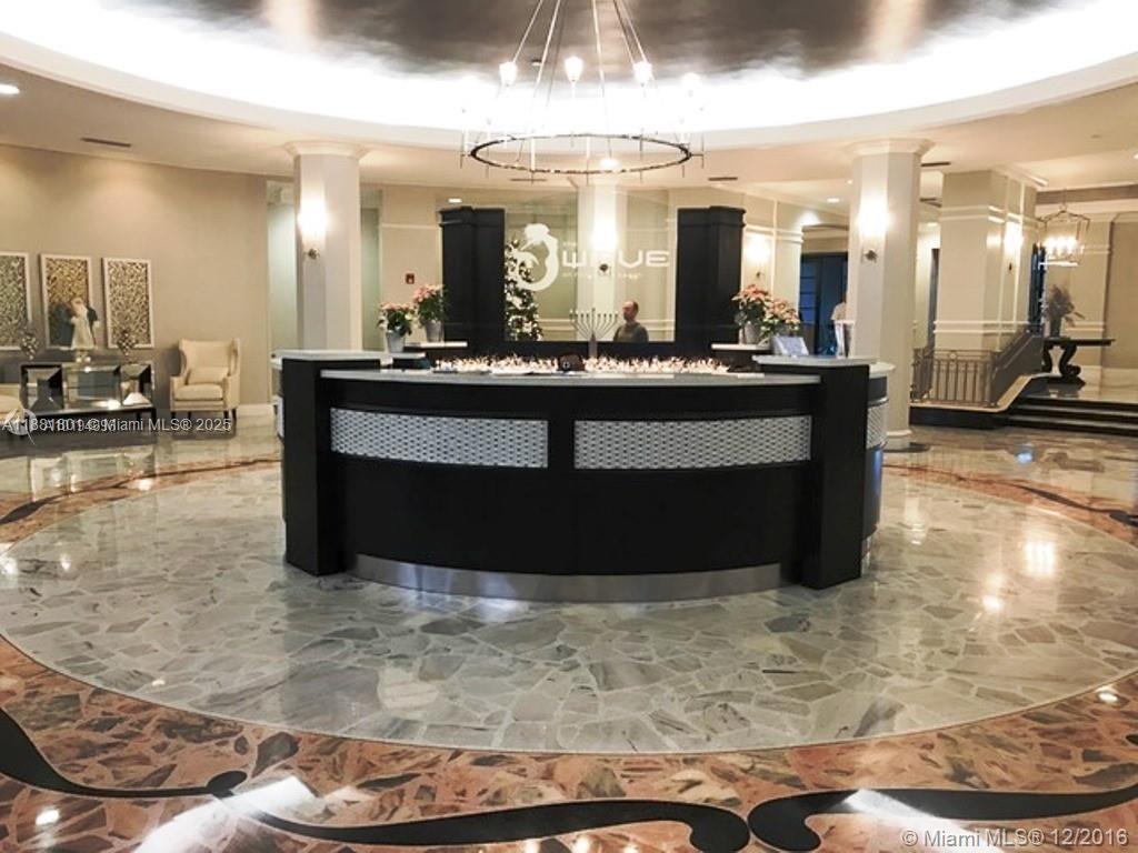 A lobby features a curved reception desk, marble flooring, and a large chandelier — 2501 S Ocean Dr # 336, Hollywood FL 33019, HOLLYWOOD, FL