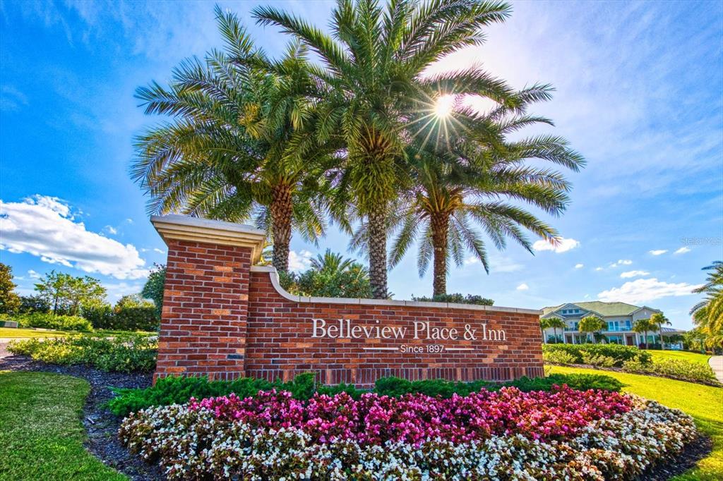 A brick monument sign for Belleview Place & Inn stands before palm trees and flowers — 125 BELLEVIEW BOULEVARD UNIT 302, BELLEAIR, FL