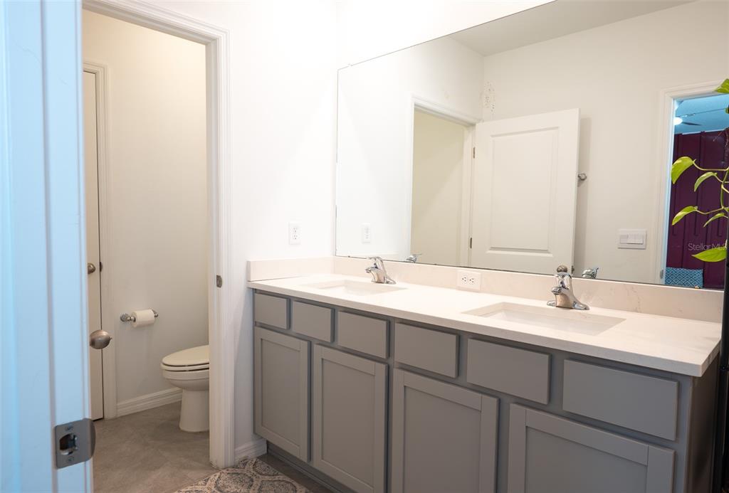 A tiled entryway features a white front door, a console table, and two interior doors — 35606 KINSEY POINT, ZEPHYRHILLS, FL