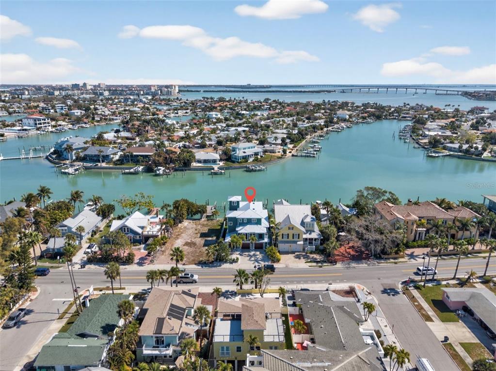 An aerial view shows a waterfront house with a red pin on a canal — 2503 PASS A GRILLE WAY, ST PETE BEACH, FL