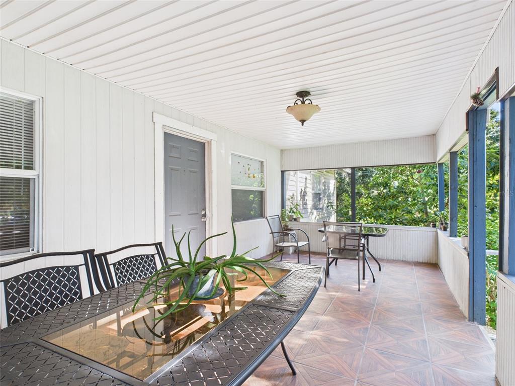 A front porch with white railings leads to a dark gray door and tiled entryway — 13014 LINCOLN ROAD, RIVERVIEW, FL