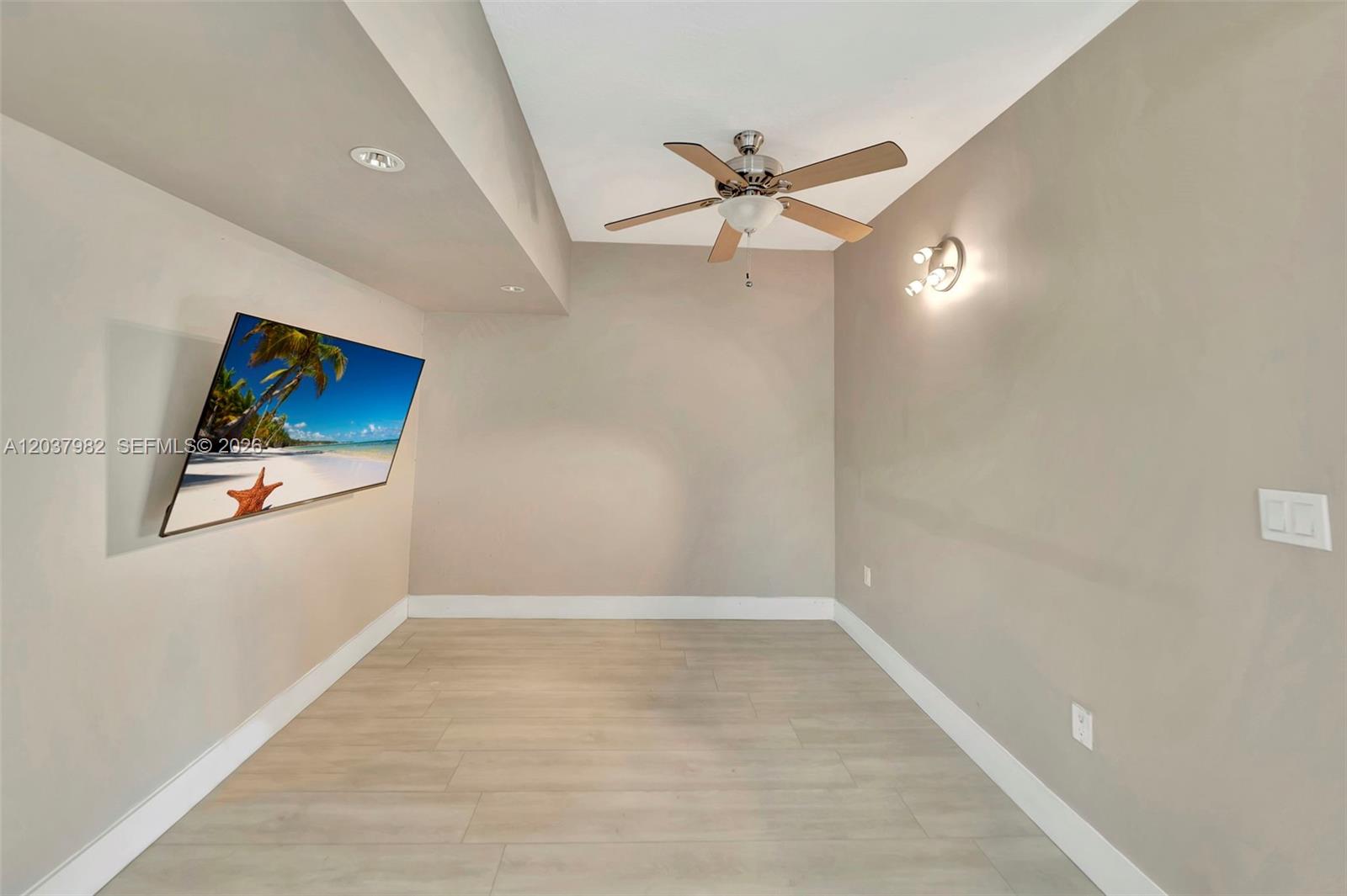 A room with light-colored wood-look flooring, a ceiling fan, and a wall-mounted television — 3773 SW 153rd Ct # 3773, Miami FL 33185, MIAMI, FL