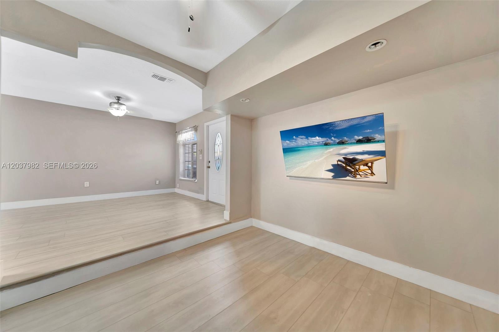 A living area features light wood-look flooring, a sunken section, and a wall-mounted television — 3773 SW 153rd Ct # 3773, Miami FL 33185, MIAMI, FL