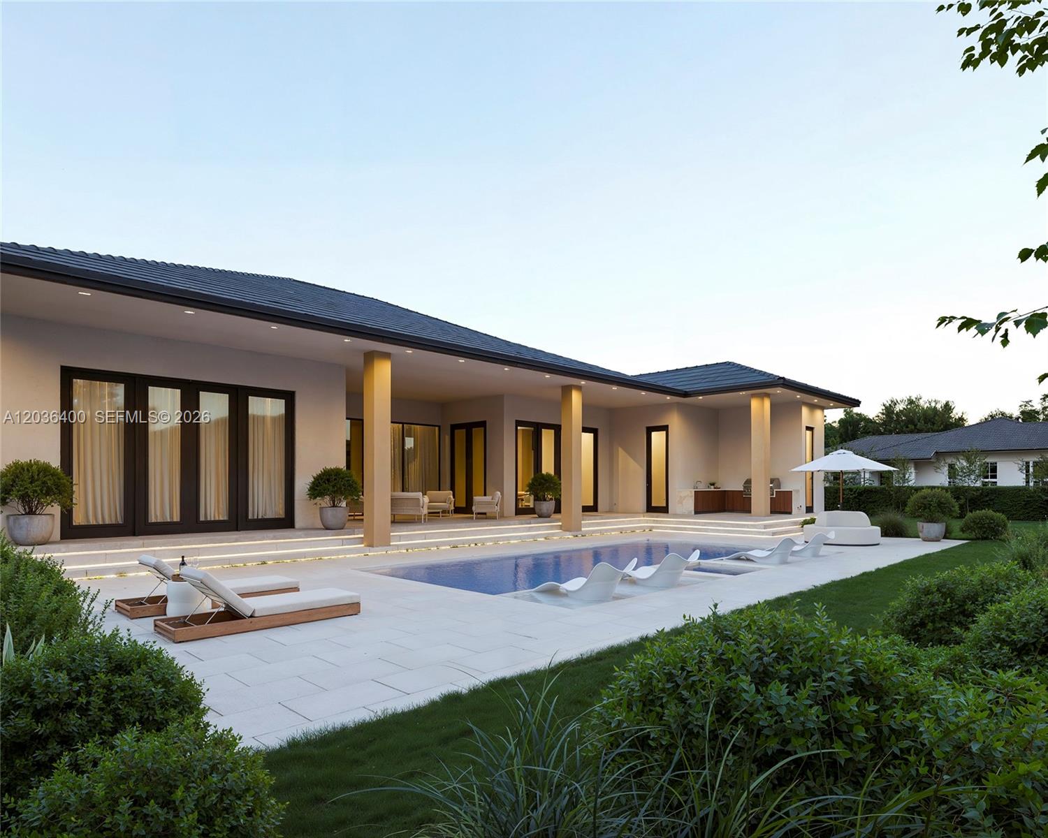 This exterior view shows a modern house with a pool, patio, and outdoor kitchen — 12720 SW 188 ST, Miami FL 33177, MIAMI, FL