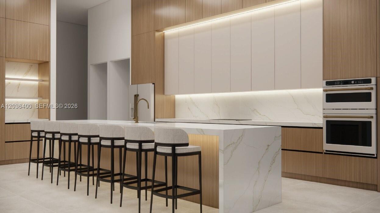 This rendering shows a modern kitchen with a marble waterfall island and wood cabinetry — 12720 SW 188 ST, Miami FL 33177, MIAMI, FL
