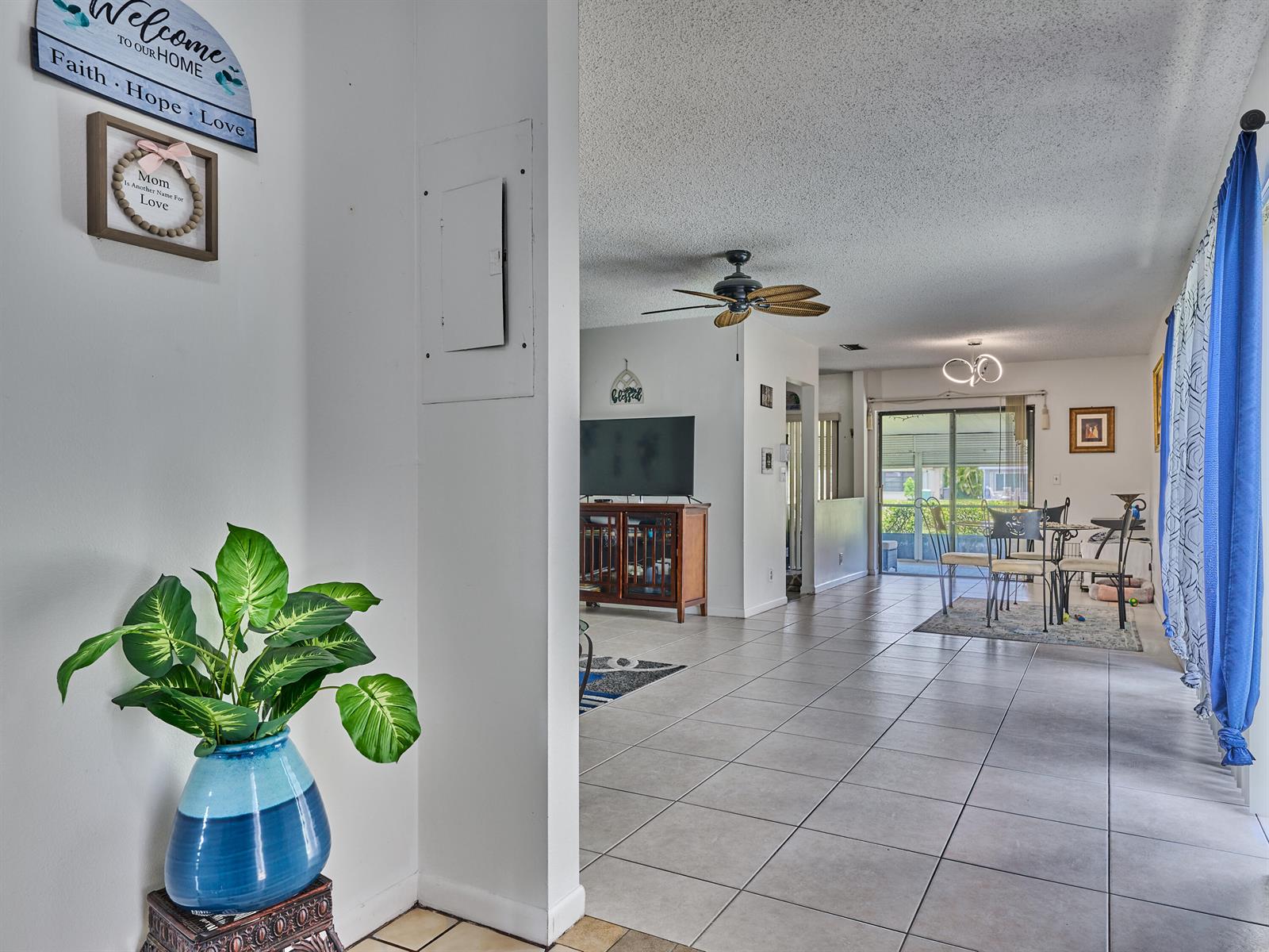 A view from a tiled entryway looking into a living and dining area with tile floors — 5197 Minto Road, Boynton Beach FL 33472, BOYNTON BEACH, FL