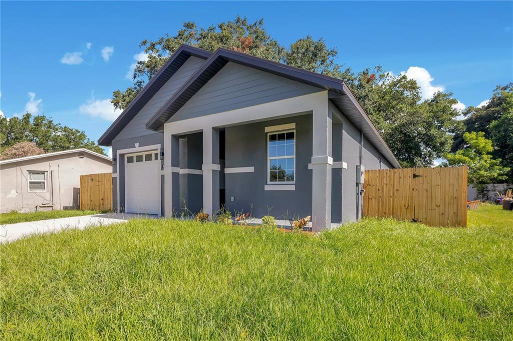 A gray single-story house with a white garage door and a wooden privacy fence — 231 E LAFAYETTE STREET, WINTER GARDEN, FL