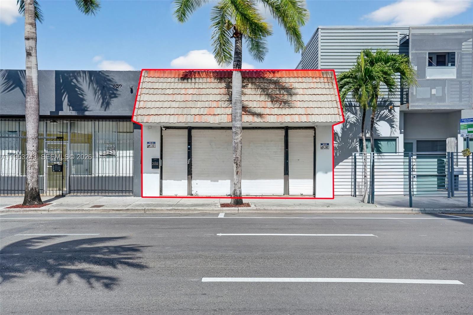 A street-level view of a small commercial building with a tiled roof and closed shutters — 2151 SW 8th St, Miami FL 33135, MIAMI, FL