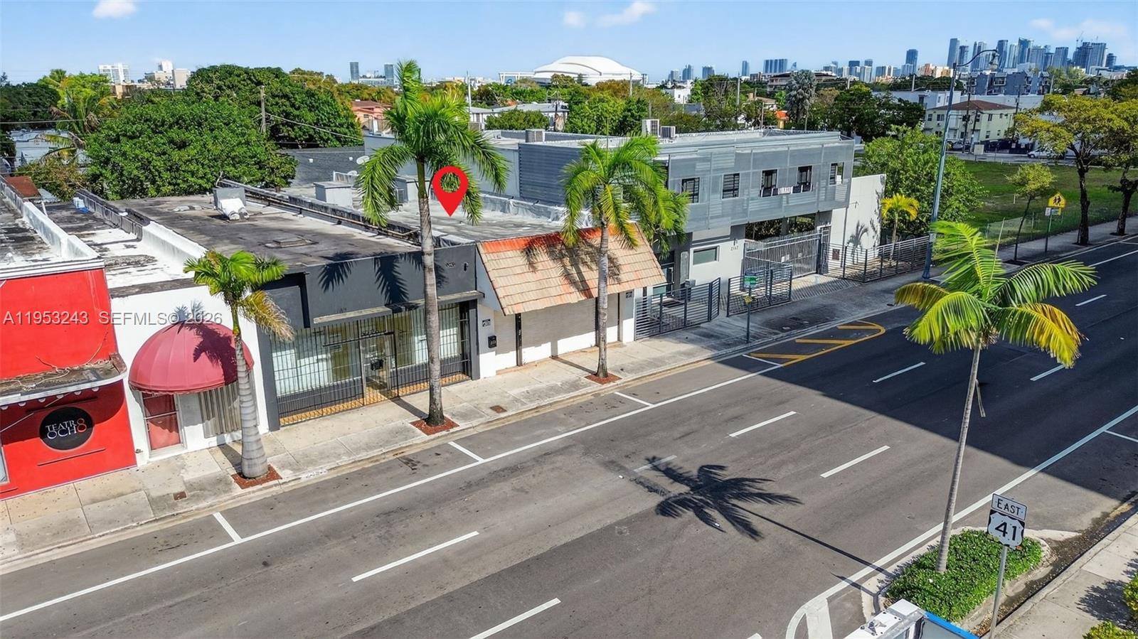 An aerial view shows a commercial building with palm trees along a city street — 2151 SW 8th St, Miami FL 33135, MIAMI, FL