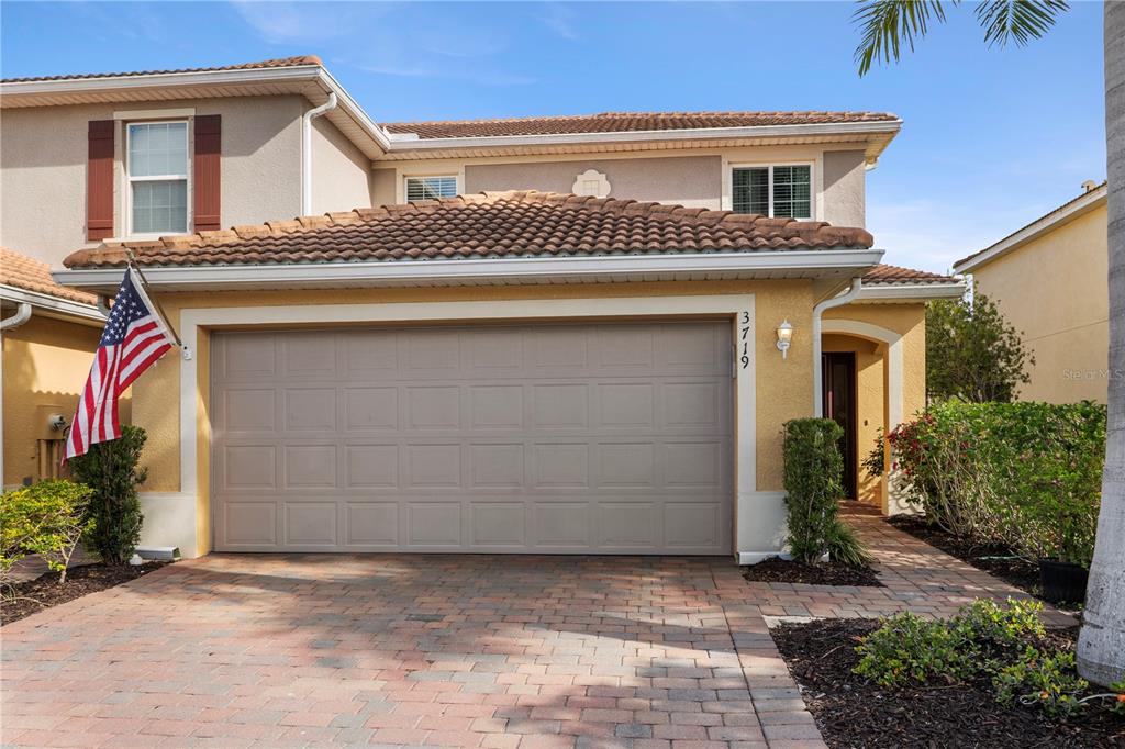 A two-story house with a beige stucco exterior, a tile roof, and a two-car garage — 3719 CROFTON COURT, FORT MYERS, FL