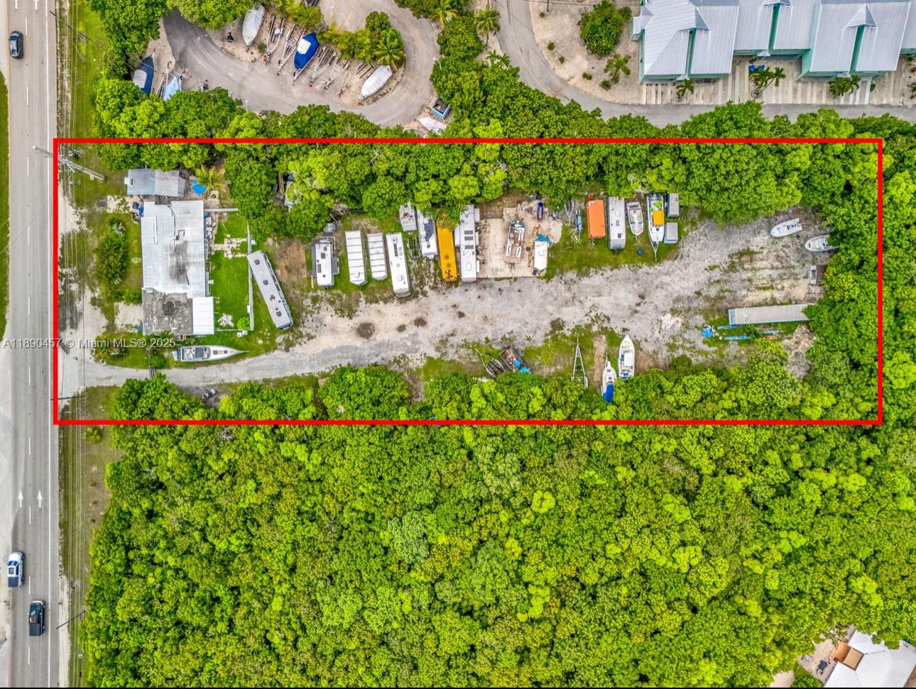 An aerial view shows a rectangular lot containing a building and multiple parked vehicles — 98468 Overseas Hwy, Key Largo FL 33037, KEY LARGO, FL