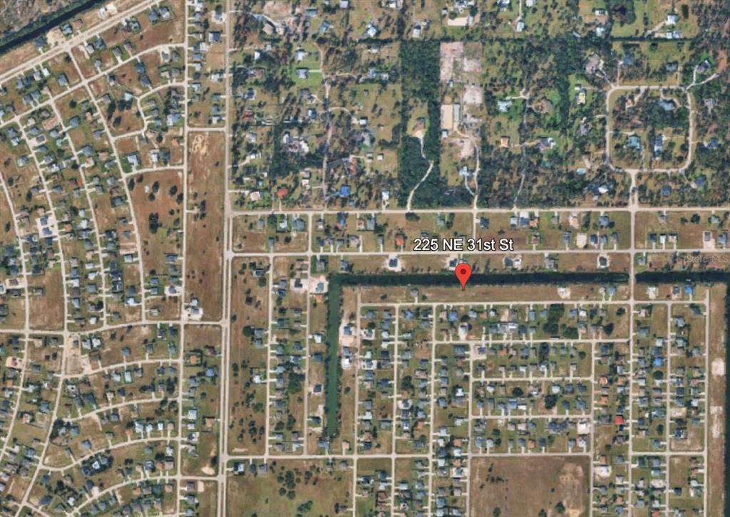 This is an aerial map view showing a vacant residential lot in a suburban neighborhood — 225 NE 31ST STREET, CAPE CORAL, FL