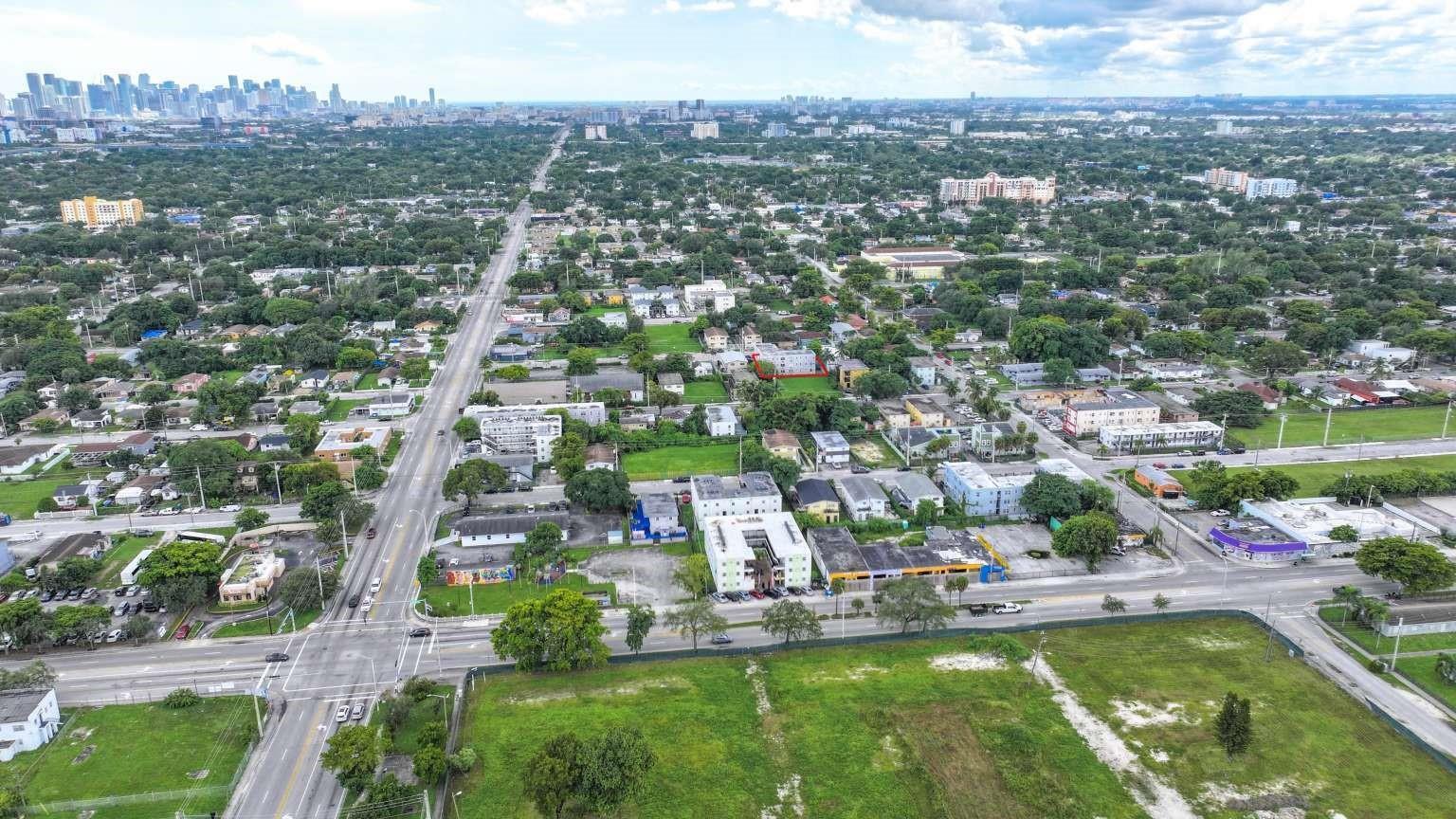 Aerial view of a multi-family residential building highlighted in red within a suburban neighborhood — 1261 NW 59th Street, Miami FL 33142, MIAMI, FL