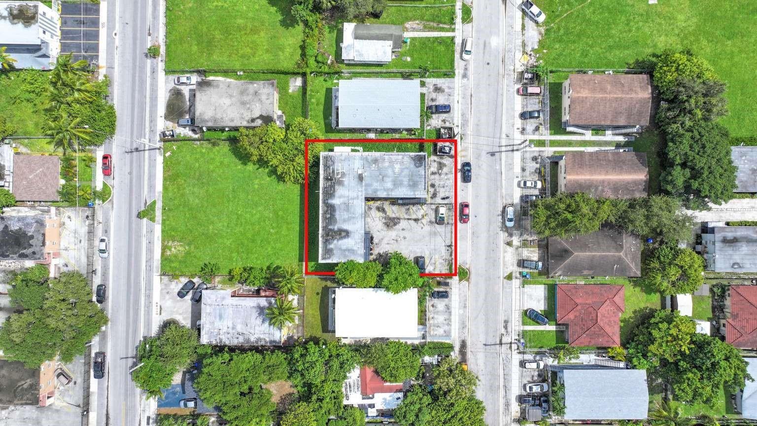 An aerial view shows a rectangular commercial building with a flat roof and parking lot — 1261 NW 59th Street, Miami FL 33142, MIAMI, FL