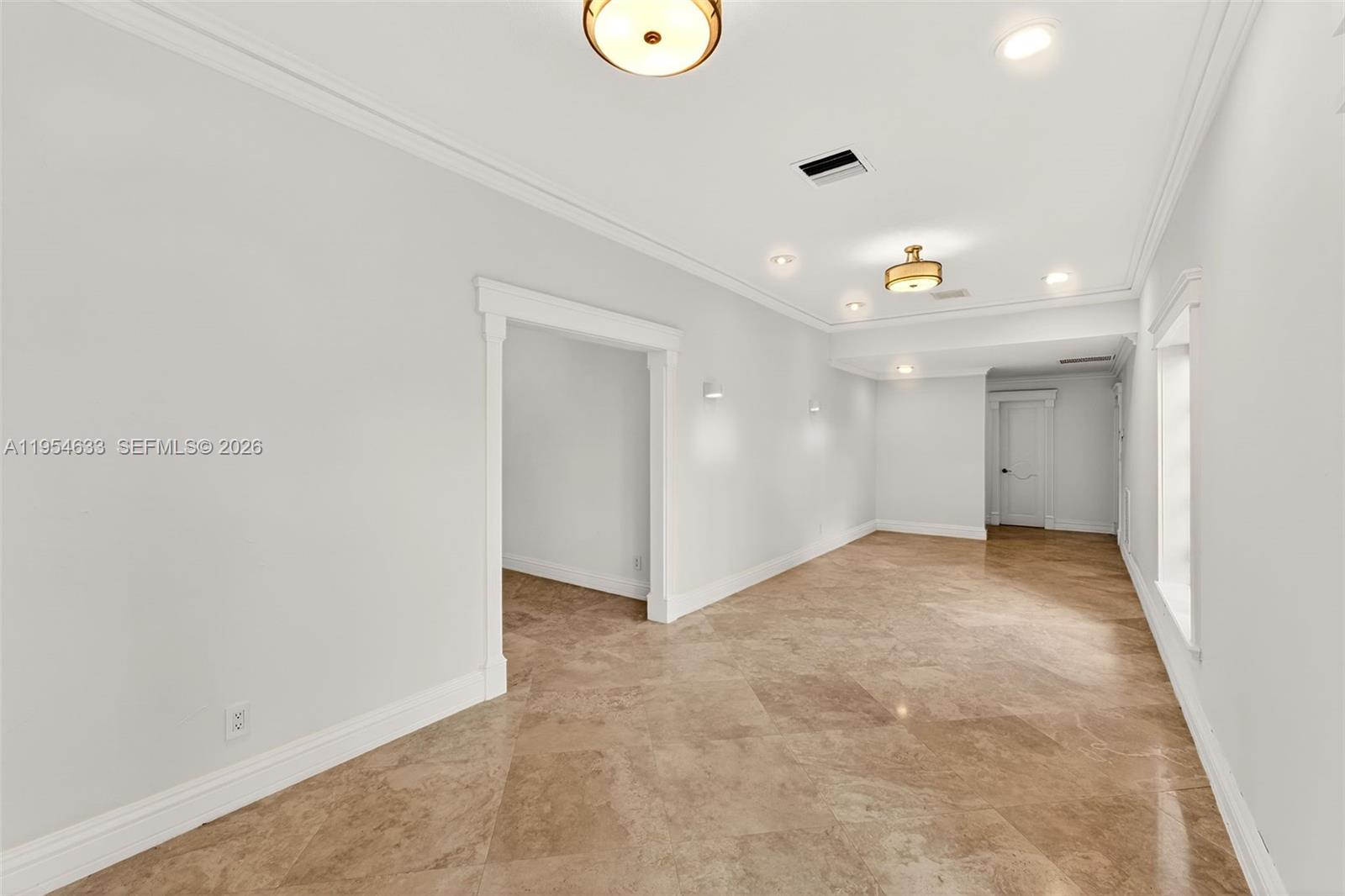 An empty room features light-colored walls, crown molding, recessed lighting, and polished tile flooring — 3000 SW 130th Ave, Miami FL 33175, MIAMI, FL