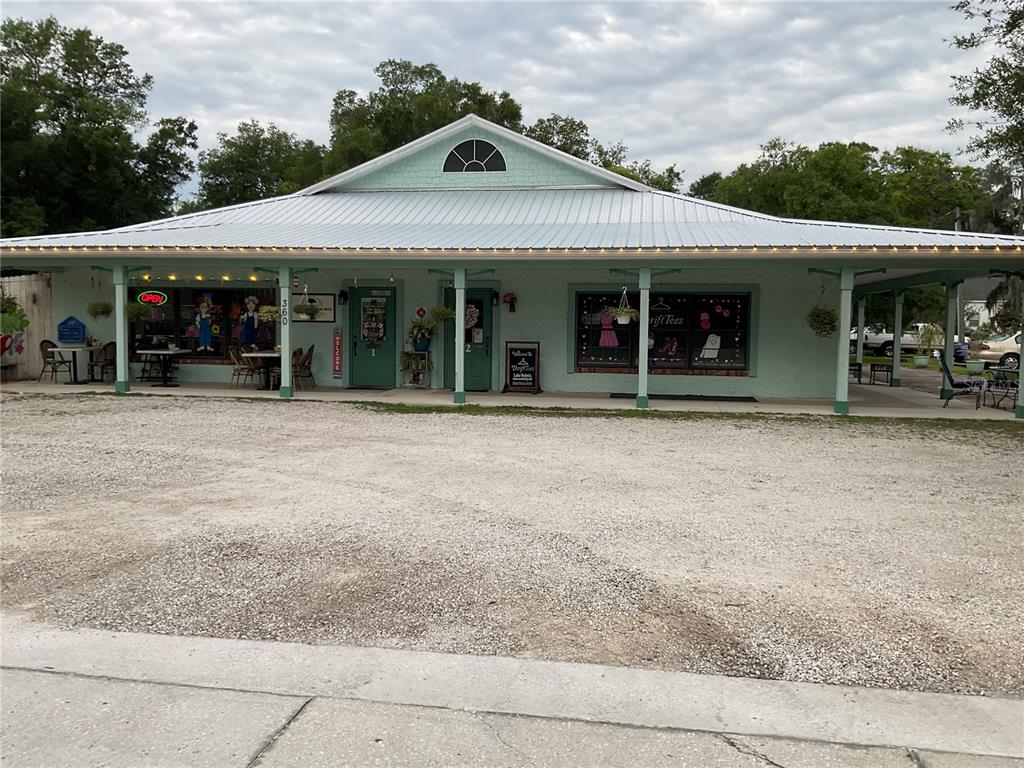 A light green, single-story commercial building with a metal roof and a gravel parking lot — 360 S LAKEVIEW DRIVE, LAKE HELEN, FL
