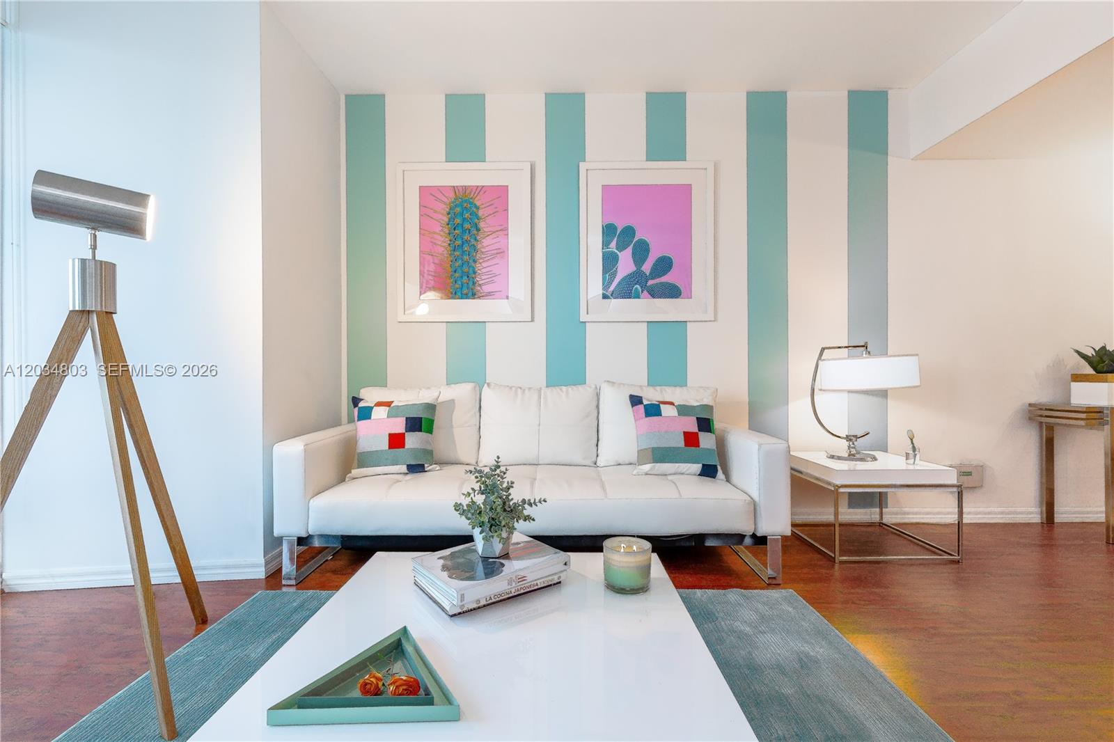 A living room features a white sofa, striped accent wall, and a modern coffee table — 485 Brickell Ave # 3211, Miami FL 33131, MIAMI, FL