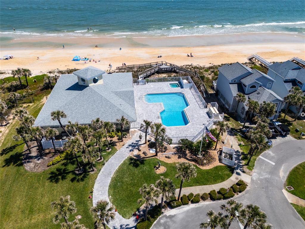 An aerial view shows a beach house with a swimming pool and a private boardwalk — 24 MEDFORD DRIVE, PALM COAST, FL