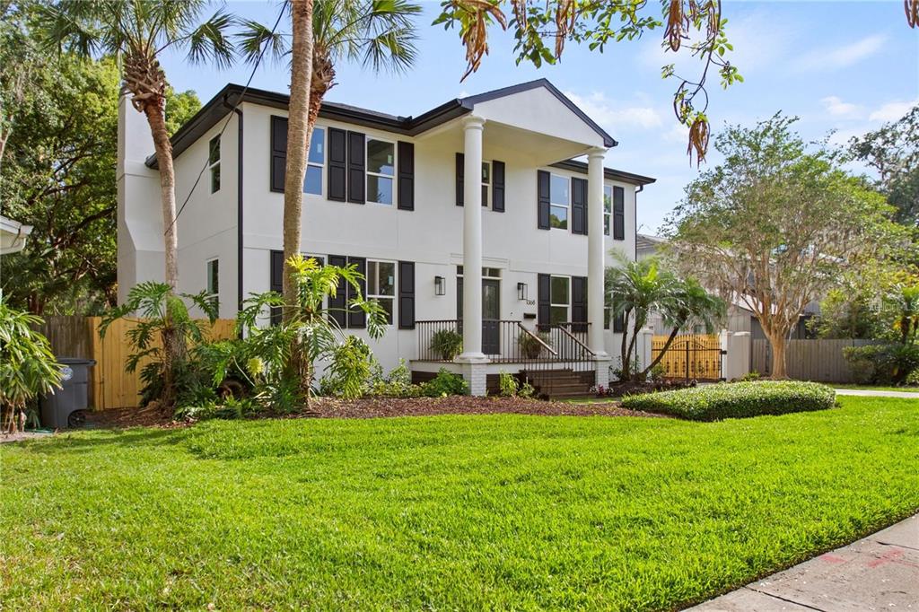 A two-story white house with black shutters and a front porch with two white columns — 1368 HIBISCUS AVENUE, WINTER PARK, FL