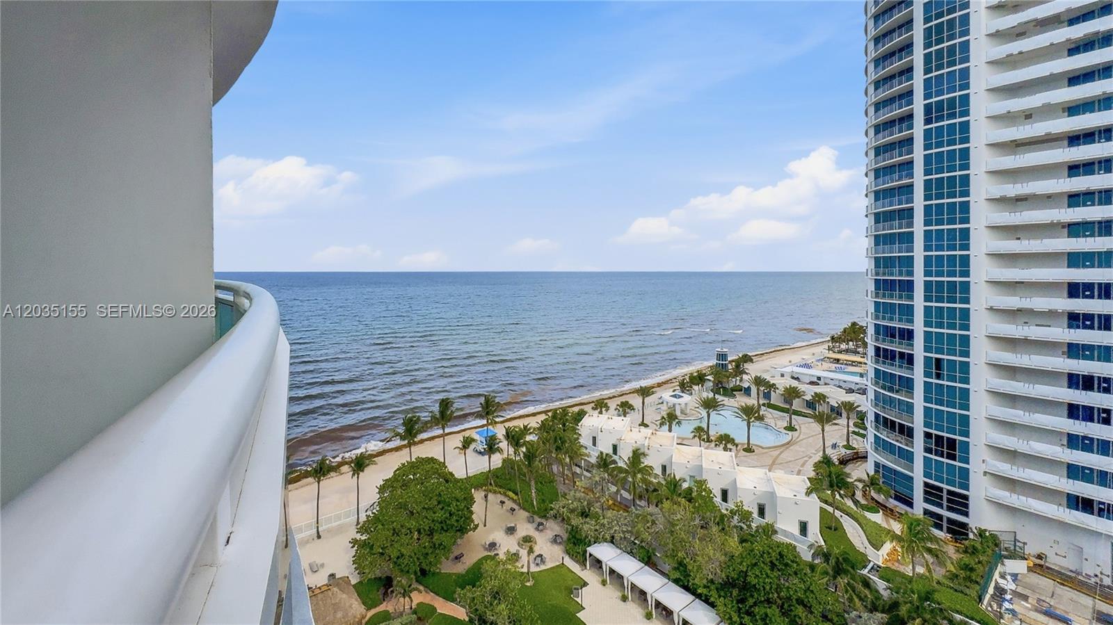 A high-rise balcony overlooks a beach, a swimming pool, and a neighboring residential tower — 3001 S Ocean Dr # 1415, Hollywood FL 33019, HOLLYWOOD, FL